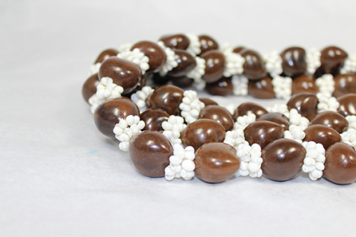 brown kukui nut leis with white shells