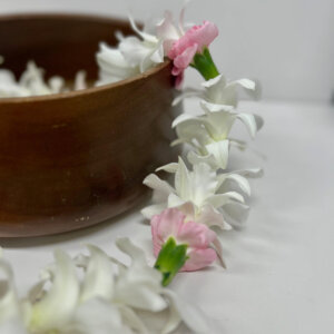 white orchid lei with pink carnations