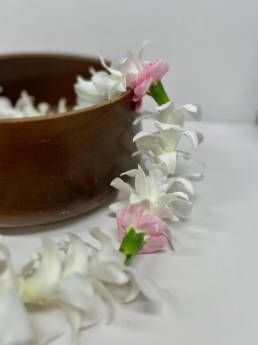 white orchid lei with pink carnations