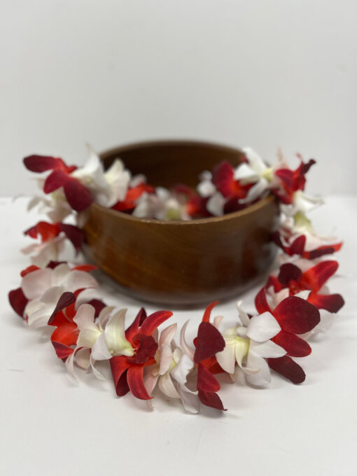 white orchid lei with red orchids